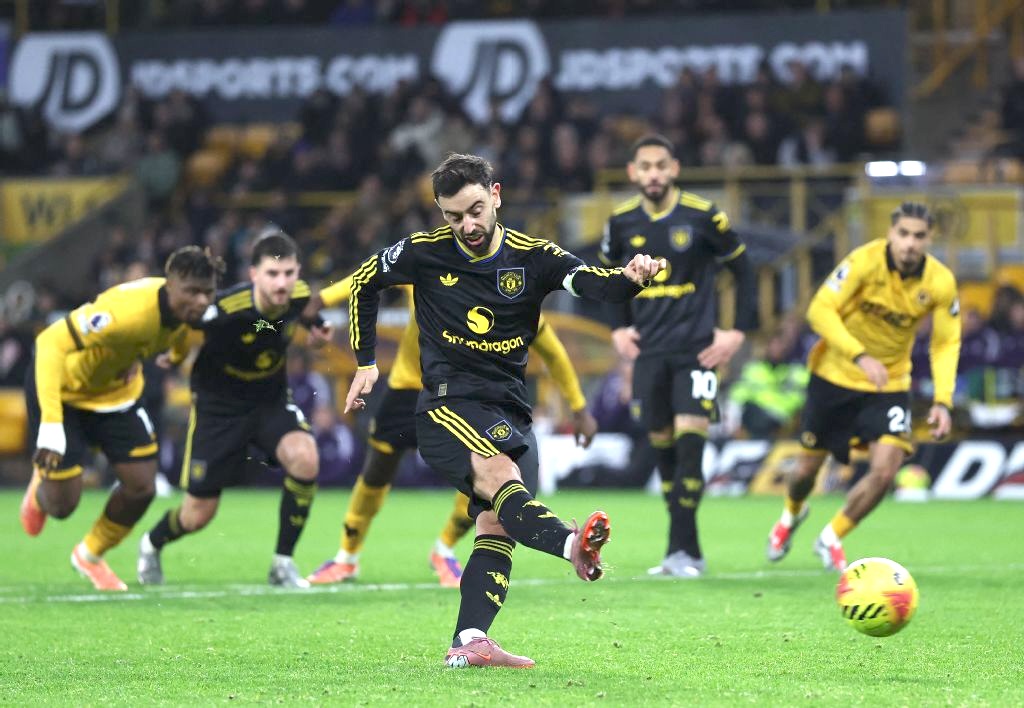 Portuguese midfielder Bruno Fernandes shoots from the penalty spot to score Manchester United’s fourth goal during their English Premier League football match against Wolverhampton Wanderers on Monday. (AFP)