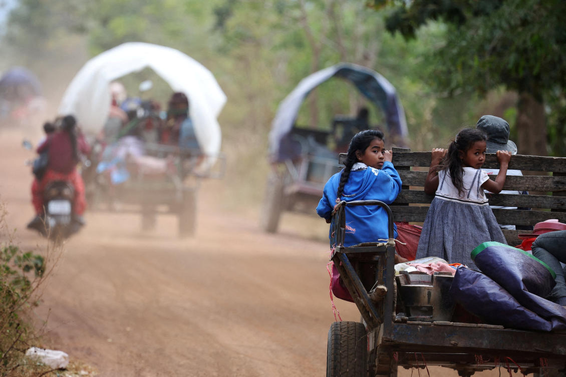 Girls sit behind a tractor on the way to a refugee camp as they are evacuated amid deadly clashes between Thailand and Cambodia along a disputed border area, in Chong Kal, Oddar Meanchey Province, Cambodia, Dec. 10, 2025. (Reuters)