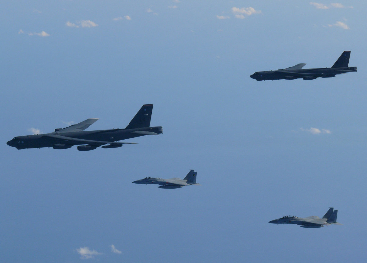 Japan Air Self-Defense Force's F-15 fighters hold a joint military drill with the US B-52 bombers over Sea of Japan on December 10, 2025. (Japan Defense Ministry/Handout via REUTERS)