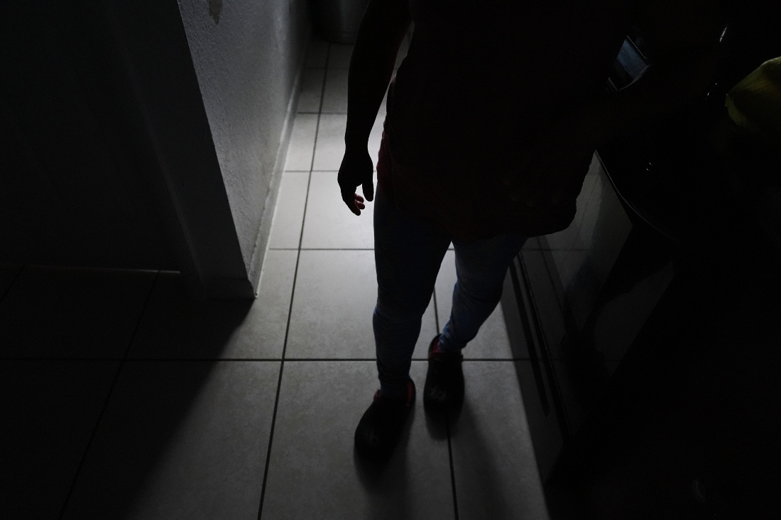 Guatemalan migrant Amavilia, 31, stands in the South Florida apartment where she lives with her two children and a roommate, after her partner Edgar was deported to Guatemala. (AP)