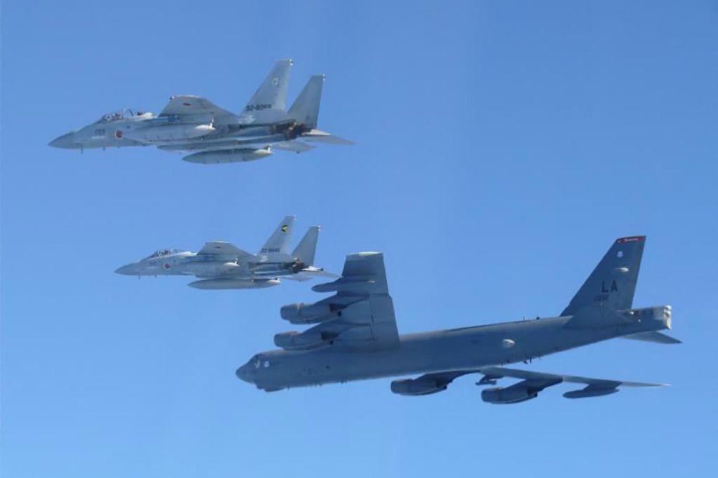 US Air Force B-52 strategic bomber (bottom) and two Japan Air Self-Defense Force F-15 fighter jets conducting a joint exercise over the Sea of Japan. (AFP)