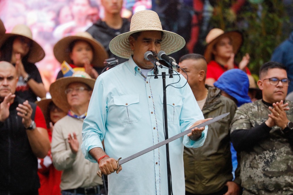 Venezuela's President Nicolas Maduro holds a sword which belonged to Ezequiel Zamora, a Venezuelan soldier and leader of the Federalists in the Federal War, as he addresses his supporters during a march to commemorate the Battle of Santa Ines, on the same day Venezuelan opposition leader Maria Corina Machado was awarded the 2025 Nobel Peace Prize in Norway, in Caracas, Venezuela, December 10, 2025. (Reuters)