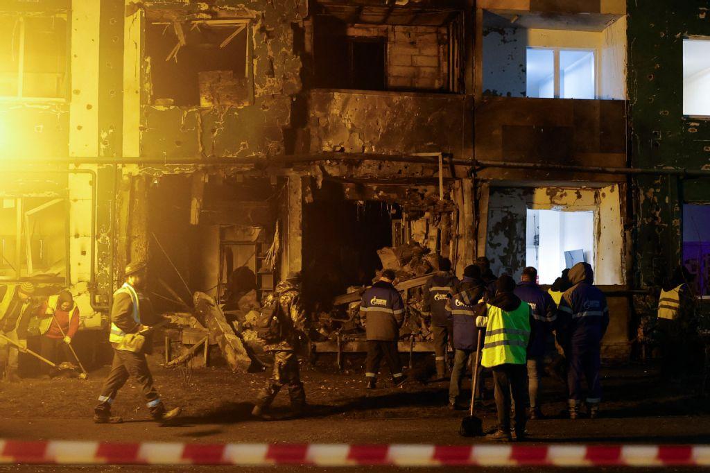 Workers clear debris at the site of a drone attack that hit a residential building in Tver on Dec. 12, 2025. (AFP)