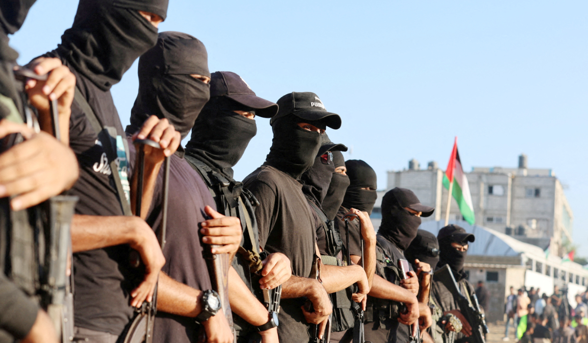 Palestinian militants stand guard on the day that hostages held in Gaza since the deadly October 7, 2023 attack, are handed over to the International Committee of the Red Cross (ICRC), as part of a ceasefire and hostages-prisoners swap deal between Hamas and Israel, in Khan Younis, southern Gaza Strip, October 13, 2025. (REUTERS)