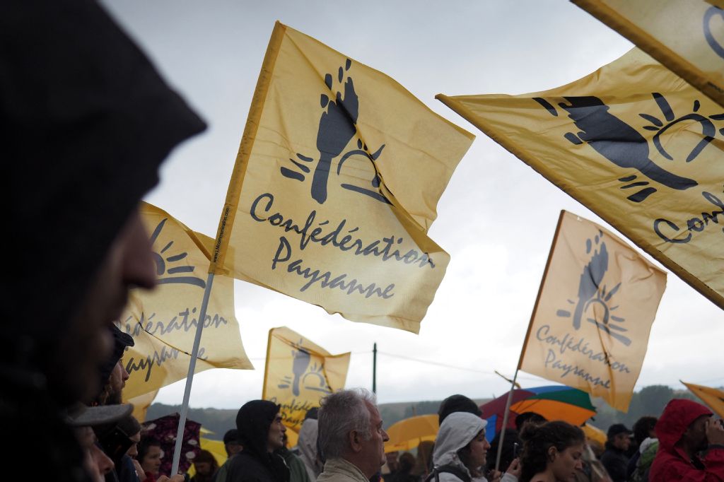 Members of French farmers union La Confederation Paysanne gather with flags at a demonstration in Murs, France. (AFP)