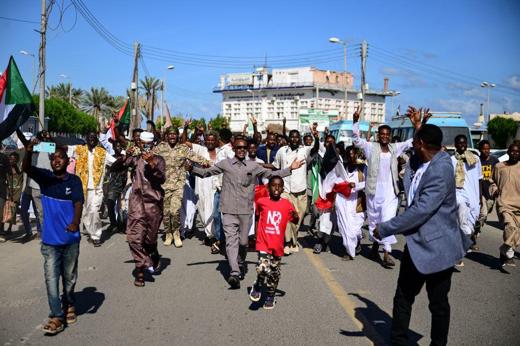 Sudanese take to the streets during a rally in support of the army, in the eastern Red Sea port of Port Sudan, on December 13, 2025. The war between the Sudanese Army and Sudan's Rapid Support Forces (RSF) which controls areas of western Sudan, erupted in April 2023, and has caused what the UN has described as the world’s worst humanitarian crisis. (Photo by Ibrahim ISHAQ / AFP)