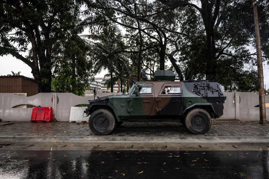 An armored vehicle is positioned at the entrance of a blocked road next to the National Television, Benin TV, in Cotonou, on Dec. 8, 2025. (AFP)