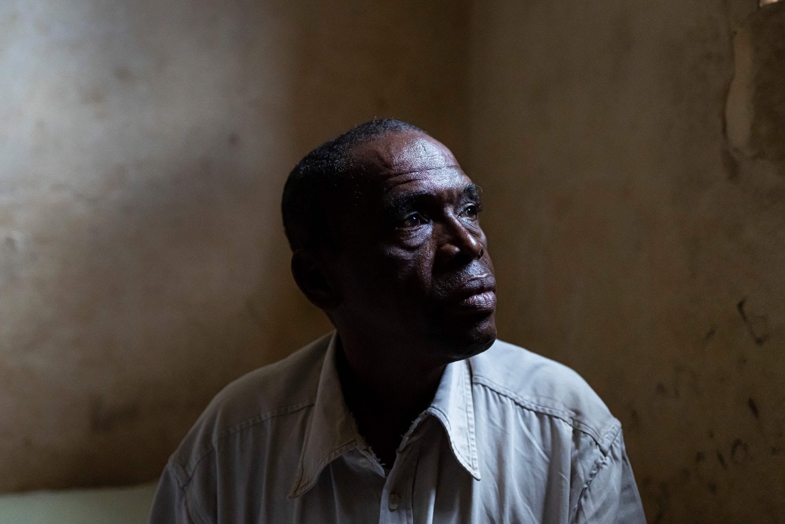 Abdoul Aziz Balde, father of Idrissa Balde, poses for a portrait inside his home in the outskirts of Conakry, Guinea. (AFP)