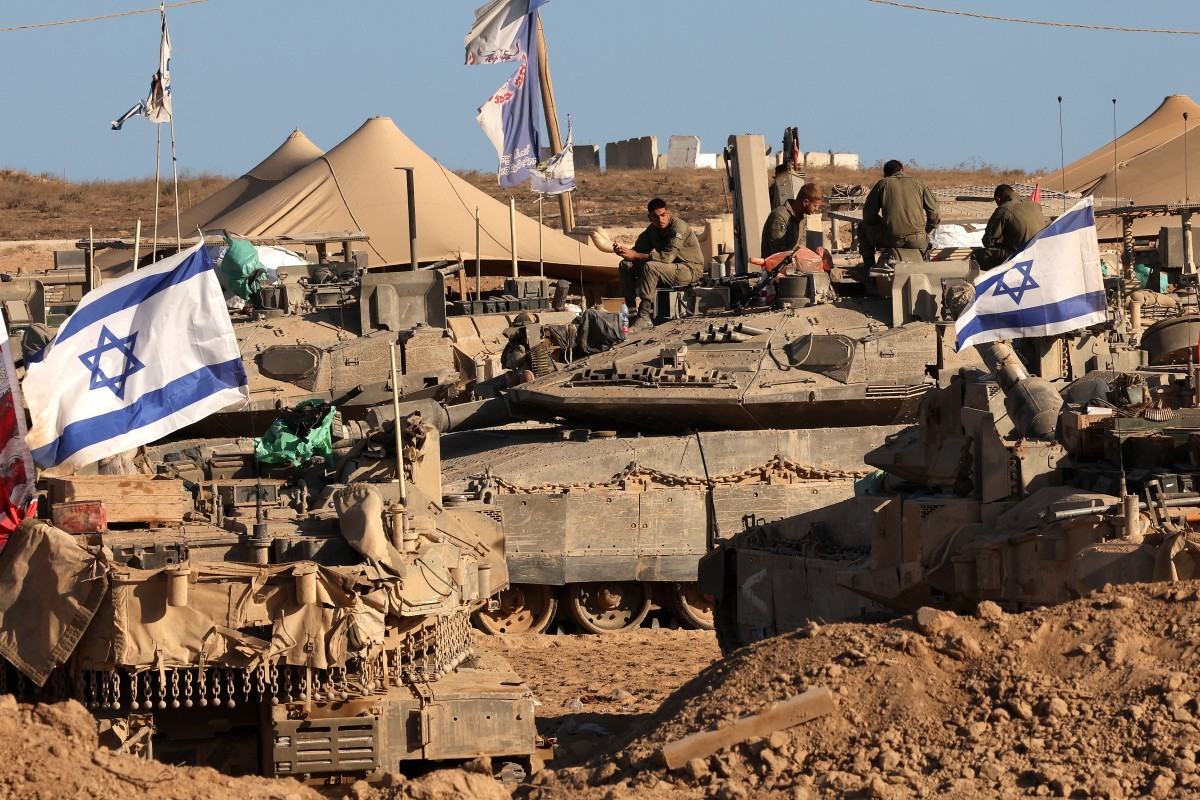 Israeli soldiers sit on top of tanks at a position in the south, near the Israel–Gaza border fence, on October 30, 2025. (File/AFP)