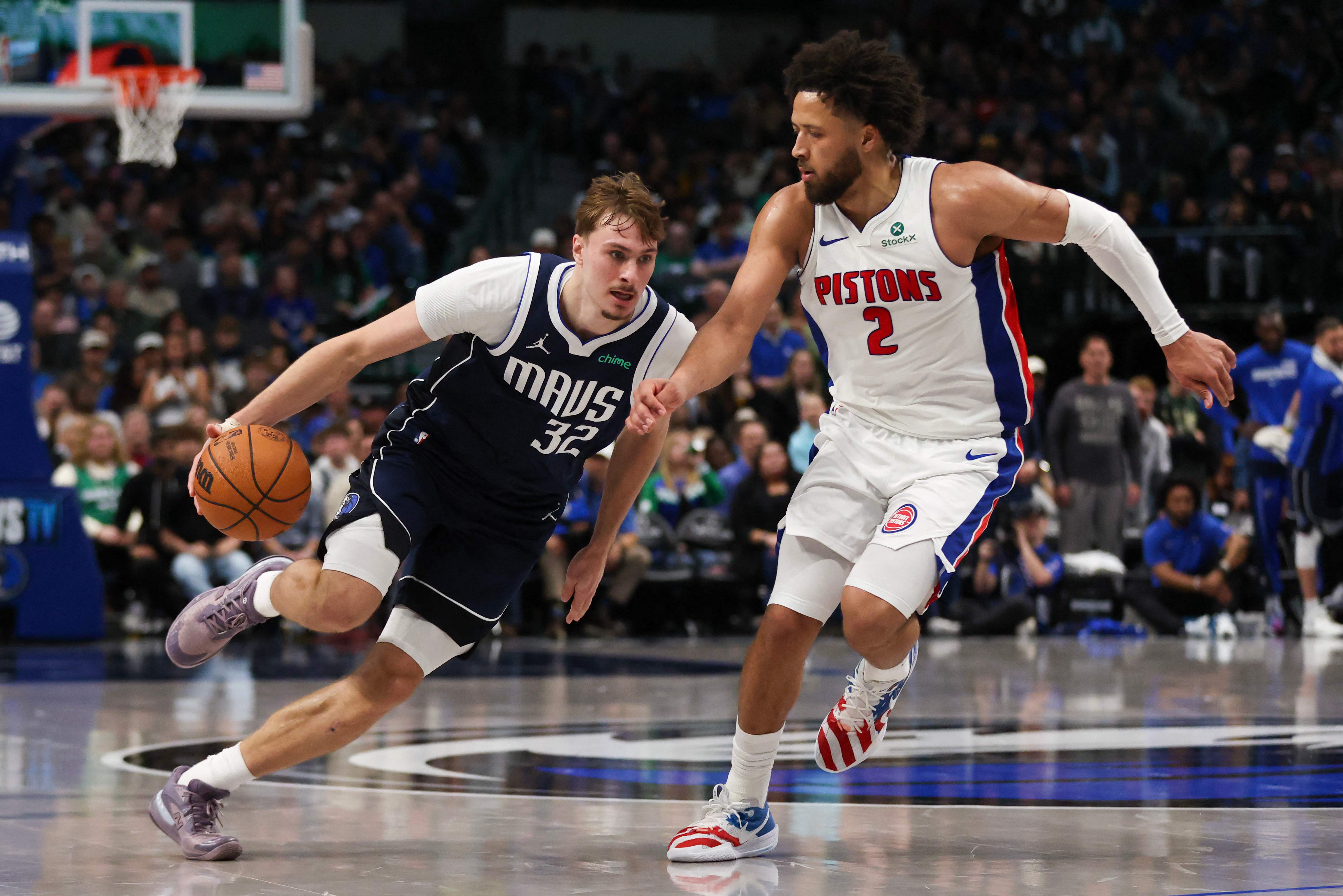 Cooper Flagg of the Dallas Mavericks drives around Cade Cunningham of the Detroit Pistons in the second half of an NBA basketball game game at American Airlines Center on Thursday in Dallas, Texas. (Getty Images via AFP)