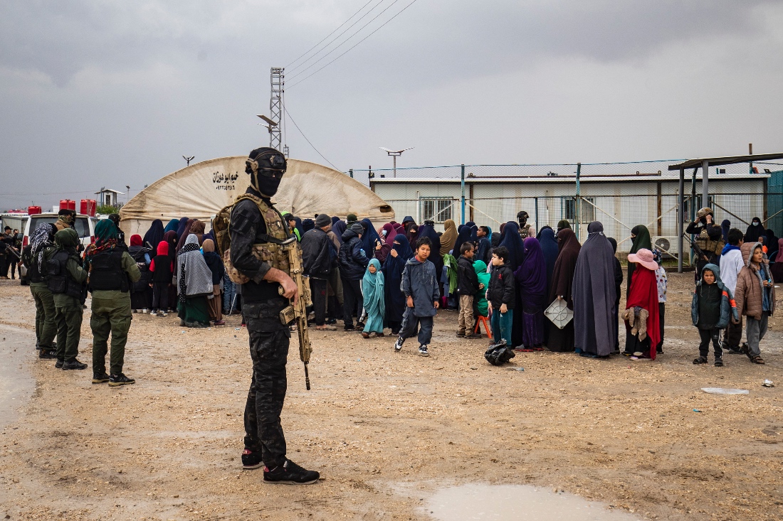 Fighters stand guard during a joint security operation for Syria's Kurdish Internal Security Police Force at camp Roj, Syria. (AFP)