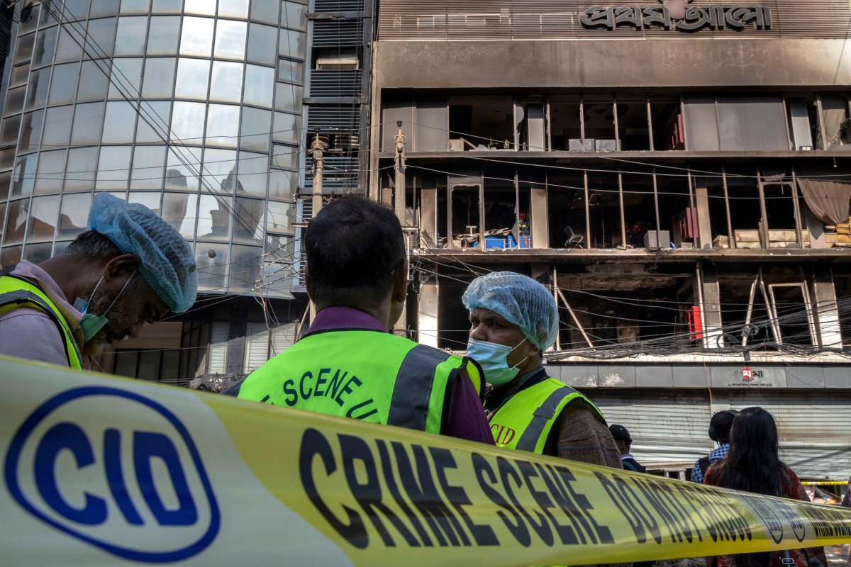 Bangladesh's Criminal Investigation Department personnel stand outside the burnt and vandalised building of the Prothom Alo newspaper in Dhaka on Dec. 19, 2025, amid protests following the news of the death of youth leader Sharif Osman Hadi. (AFP)