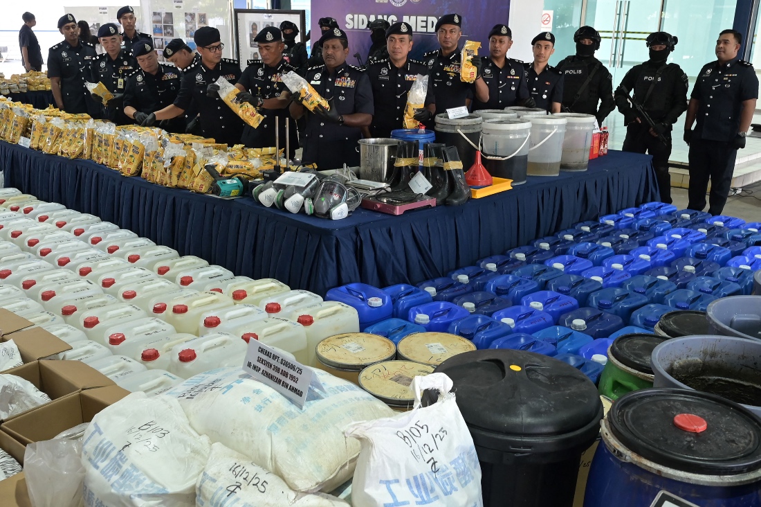 Members of the Royal Malaysia Police display seized illegal drugs and drug-making equipment during a press conference in Kuala Lumpur, Malaysia. (AFP)