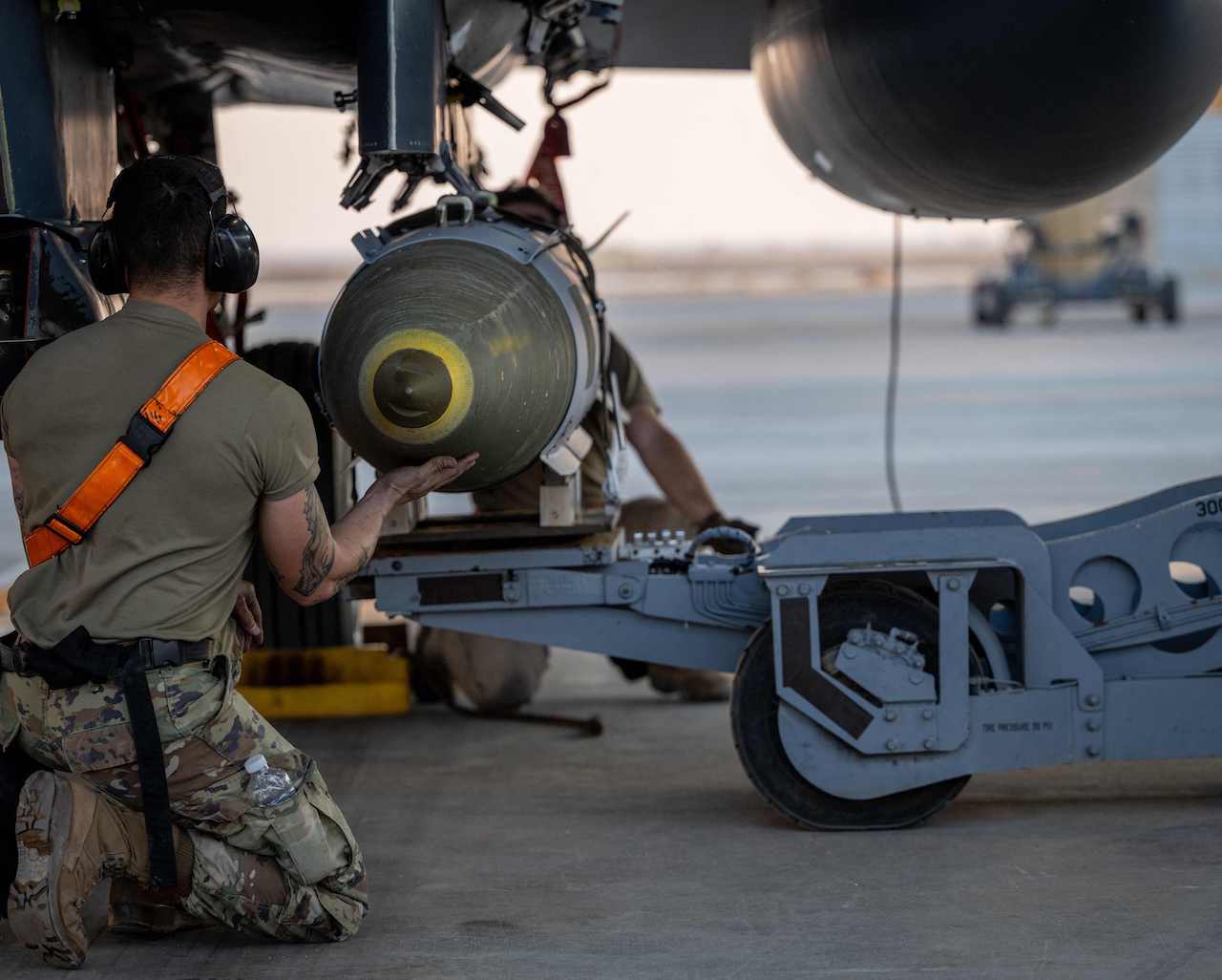 In this US Army photo released on December 19, 2025 and taken from an undisclosed location on December 18, 2025, US Airmen load GBU-31 munition systems onto an F-15E Strike Eagles within the US Central Command area of responsibility, in support of Operation Hawkeye Strike. (AFP)