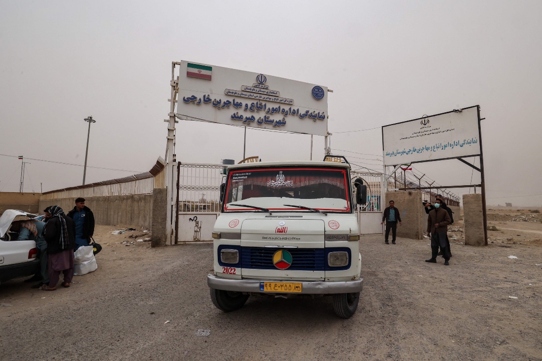 A bus carrying Afghan migrants who are being deported for reportedly failing to legalise their status in Iran leaves a camp at the Milak border crossing near the town of Zabol. (AFP)