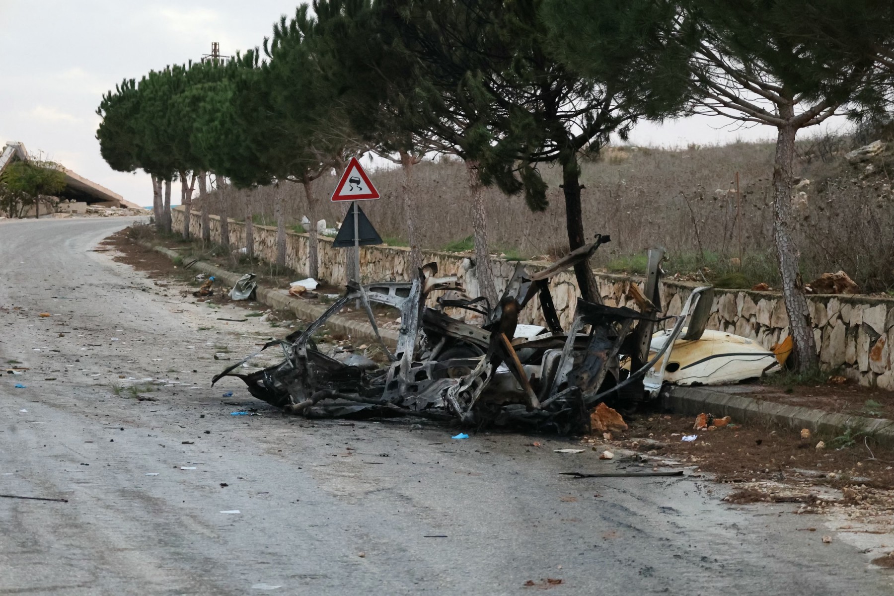 A photograph shows the wreckage of a vehicle targeted by an Israeli airstrike on the road linking the southern Lebanese border village of Odeisseh to Markaba, Dec. 16, 2025. (AFP)