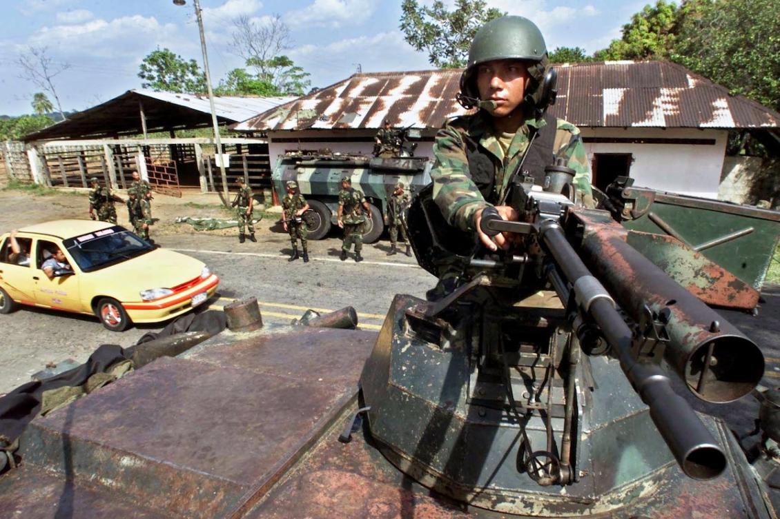 Soldiers of Colombian army maintain vigil in Doncello, Columbia 28 January 2001 some 15 kms (10 miles) from the demilitarized zone where peace talks between the government of President Andres Pastrana and guerrillas of the Revolutionary Armed Forces of Colombia (FARC) are taking place. (FILE/AFP)