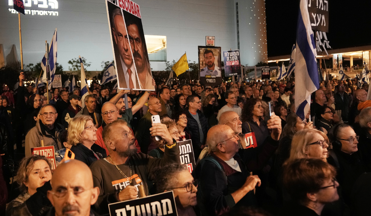People take part in a protest against Prime Minister Benjamin Netanyahu's government as they gather at Habima square, in Tel Aviv, Israel, Saturday, Dec. 20, 2025. (AP)