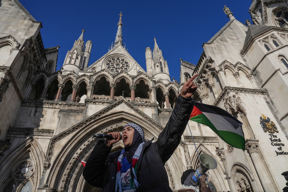 A protester takes part in a demonstration in support of "Defend Our Juries" and their campaign against the ban on Palestine Action, outside the Royal Courts of Justice, Britain's High Court, in central London on November 26, 2025. (FILE/AFP)