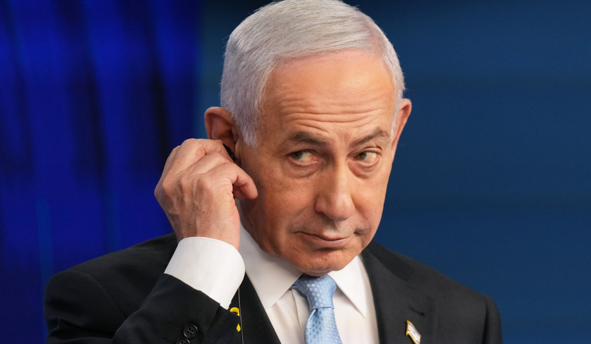 Israeli Prime Minister Benjamin Netanyahu adjusts the headphones during a joint press conference with German Chancellor Friedrich Merz in Jerusalem Sunday, Dec. 7, 2025. (AP)