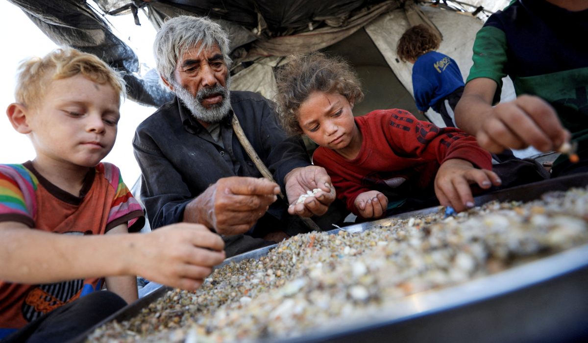 Displaced Palestinians who have not received humanitarian aid gather as they survive on leftover food, amid a hunger crisis, in Gaza, July 28, 2025. (REUTERS)