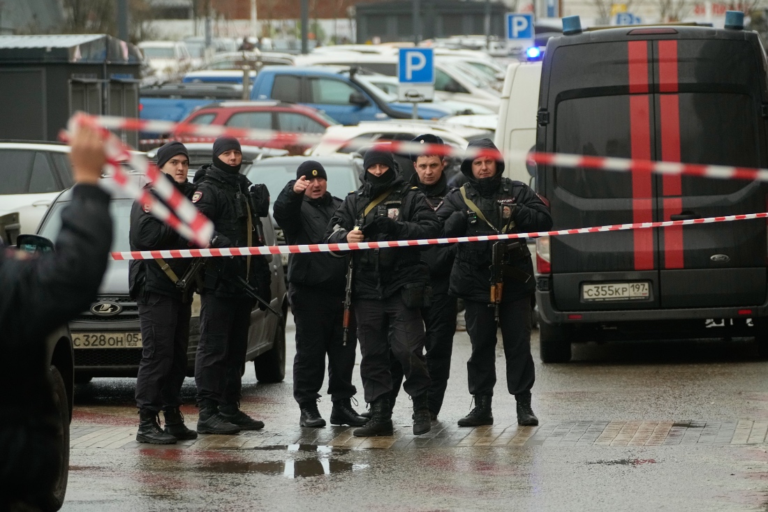 Policemen secure the area near the scene where Lt. Gen. Fanil Sarvarov, head of the Operational Training Directorate of the Russian Armed Forces General Staff, was killed by an explosive device placed under his car in Moscow, Russia. (AP)