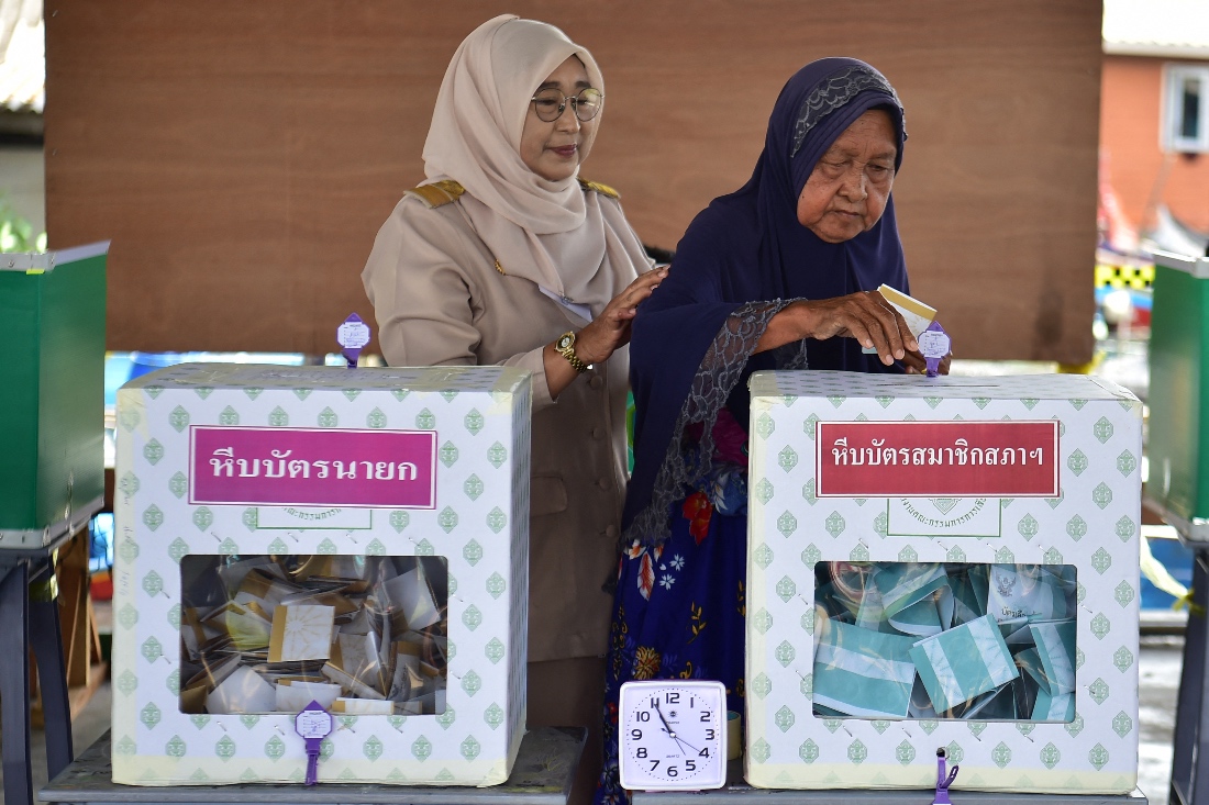 An elderly voter casts her ballot at a polling station during nationwide elections, in Narathiwat, Thailand. (AFP)
