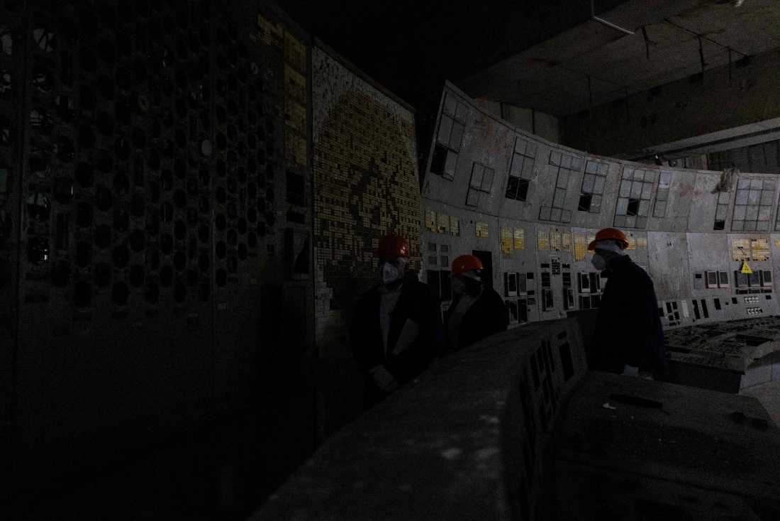 Employees stand at the control panel of the fourth power unit in Chernobyl Nuclear Power Plant, in Chernobyl, Ukraine. (AFP)