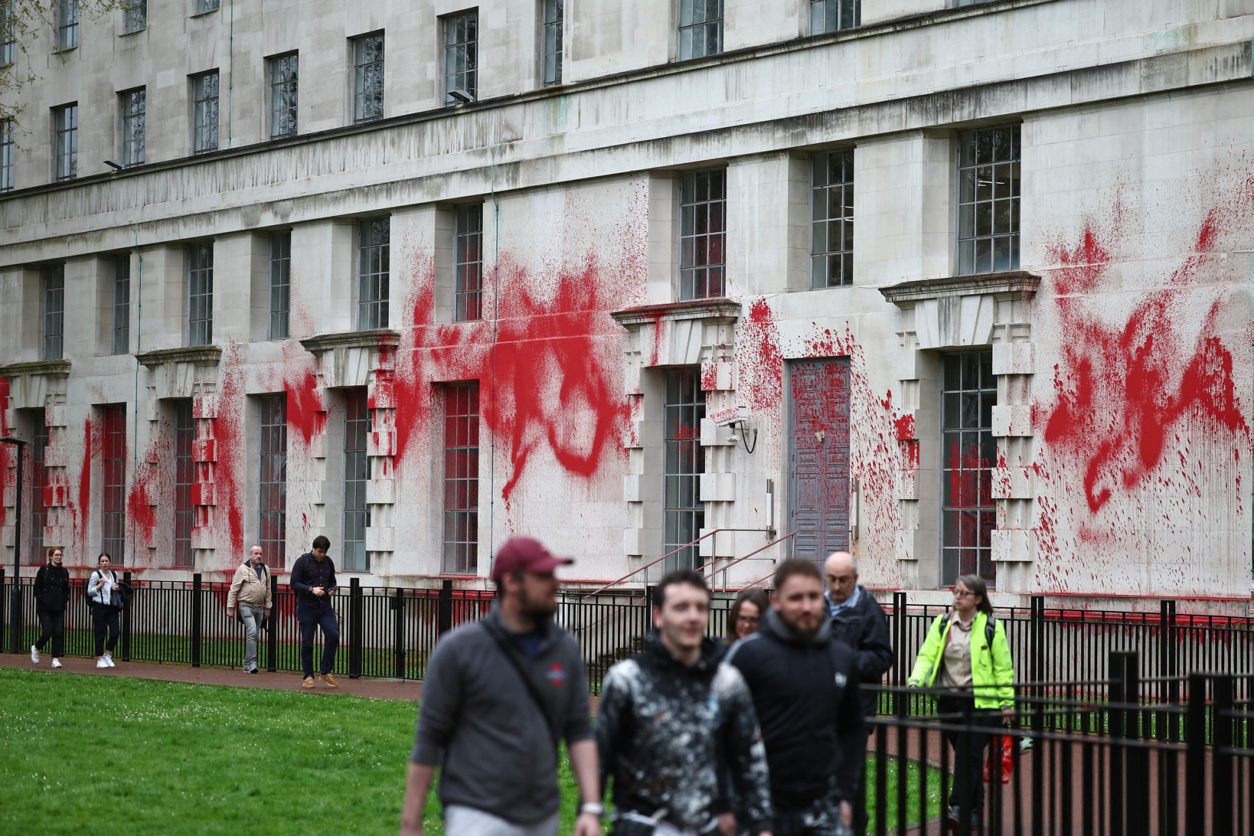 Members of the public walk past the Ministry of Defence Building in central London, hours after members of Youth Demand and Palestine Action have spayed red paint onto the brickwork to demand that the political parties in the UK impose a two-way arms embargo on Israel and end the development and production of fossil fuels in the UK, on April 10, 2024. (AFP)