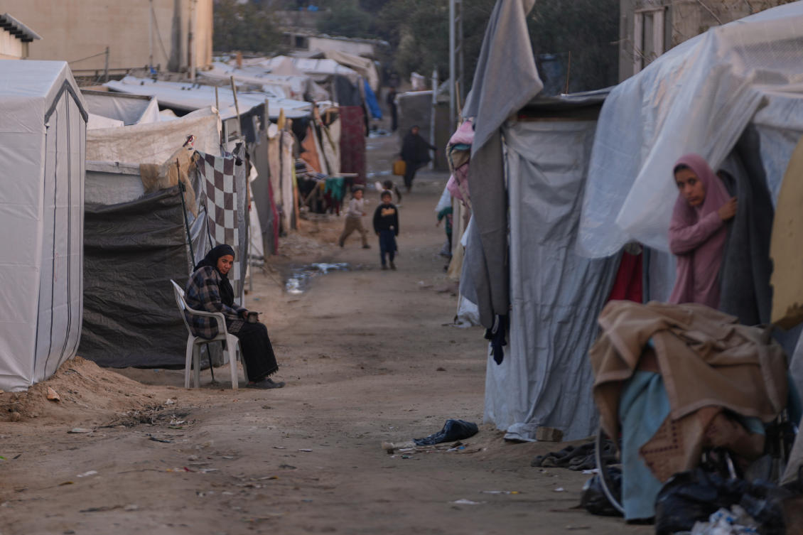 A woman sits next to her tent on an alley of a makeshift tent camp for displaced Palestinians in Deir Al-Balah, central Gaza Strip, Tuesday. (AP)