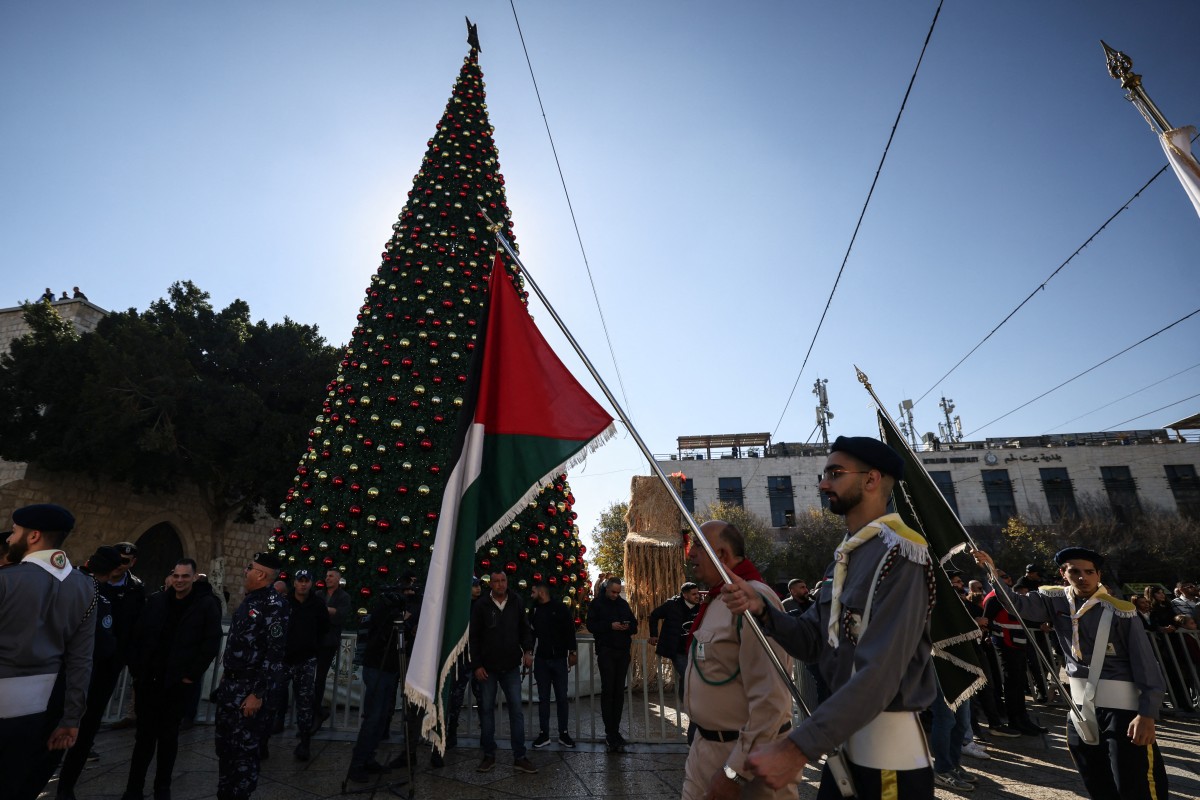 Members of the scouting movement march during Christmas eve celebrations on Manger Square outside the Church of the Nativity in Bethlehem, in the Israeli-occupied West Bank, Dec. 24, 2025. (AFP)