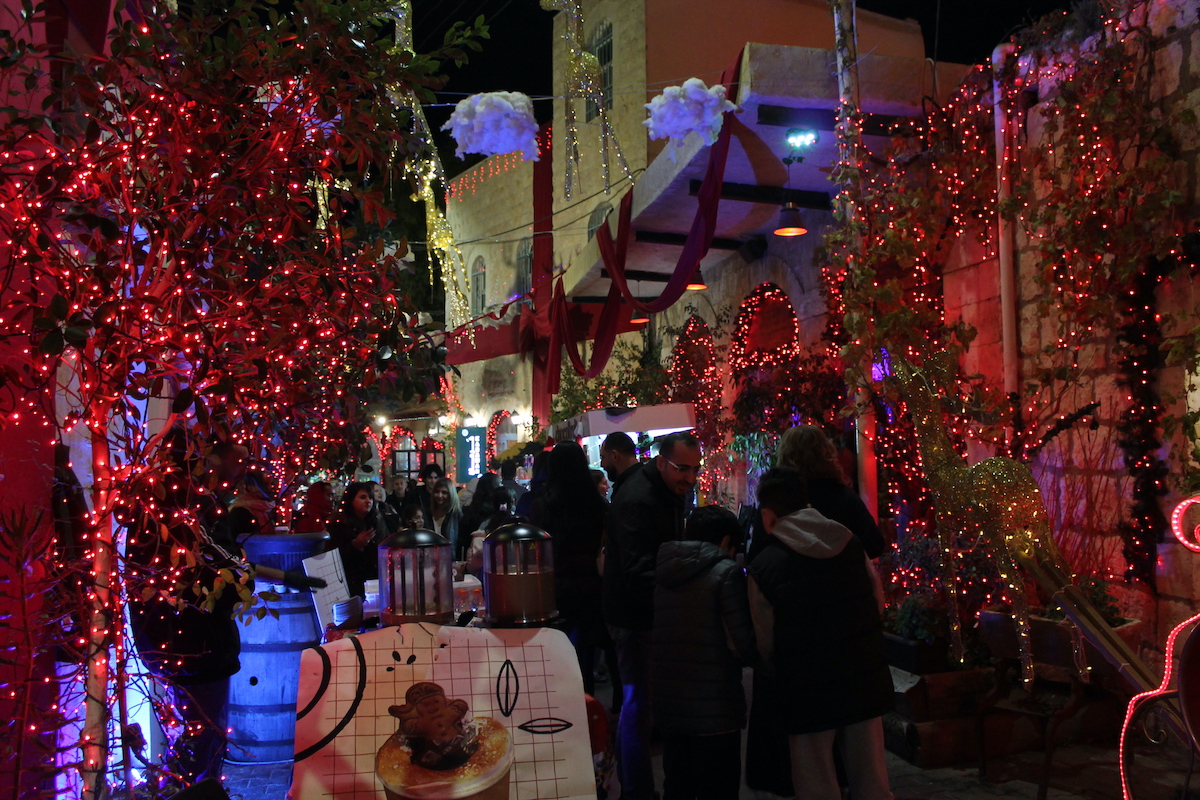 Visitors walk through a Christmas market in Fuheis, Jordan. (Rawan Baybars)