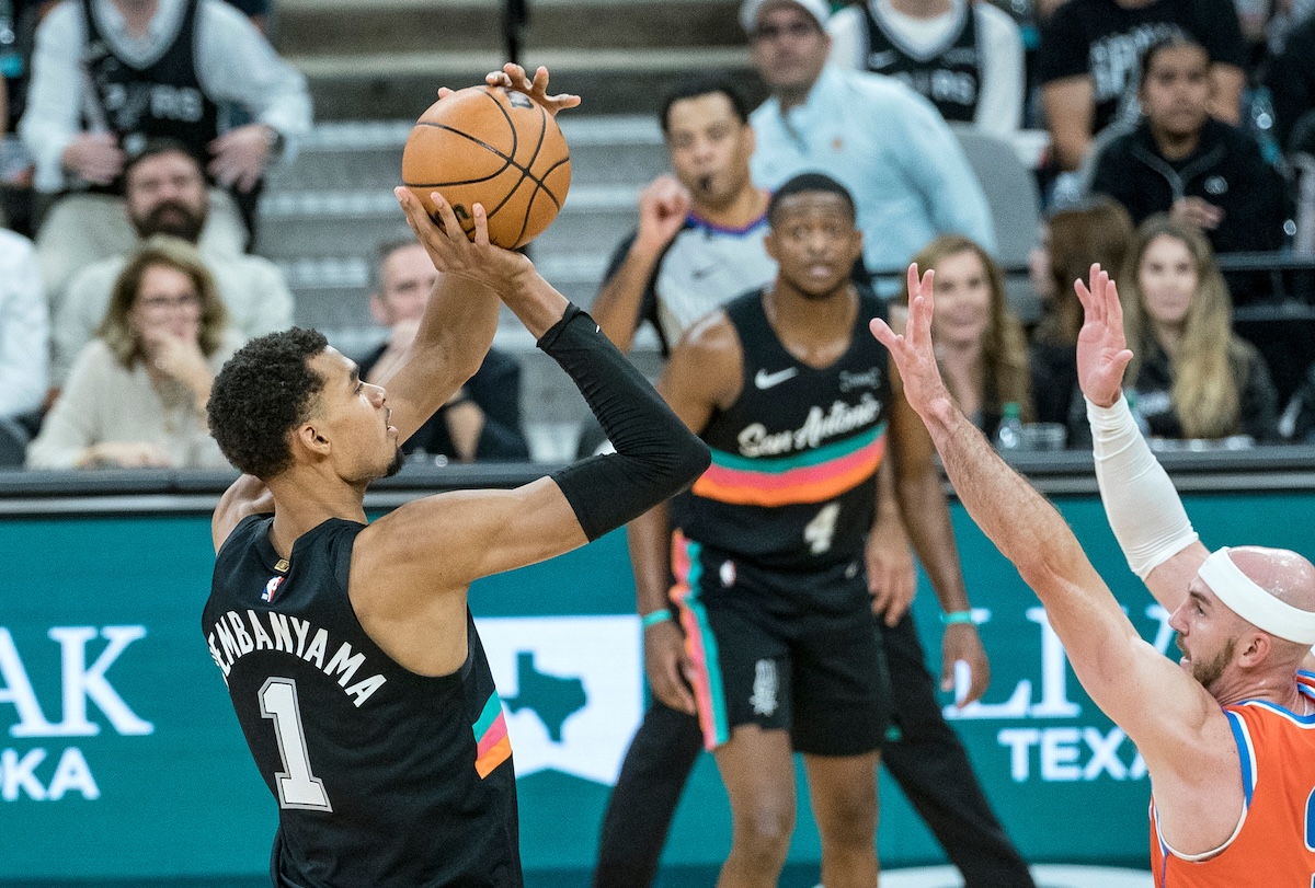 San Antonio Spurs forward Victor Wembanyama hits a three-point shot over Oklahoma Thunder guard Alex Caruso during the second half of an NBA basketball game in San Antonio Tuesday. (AP)