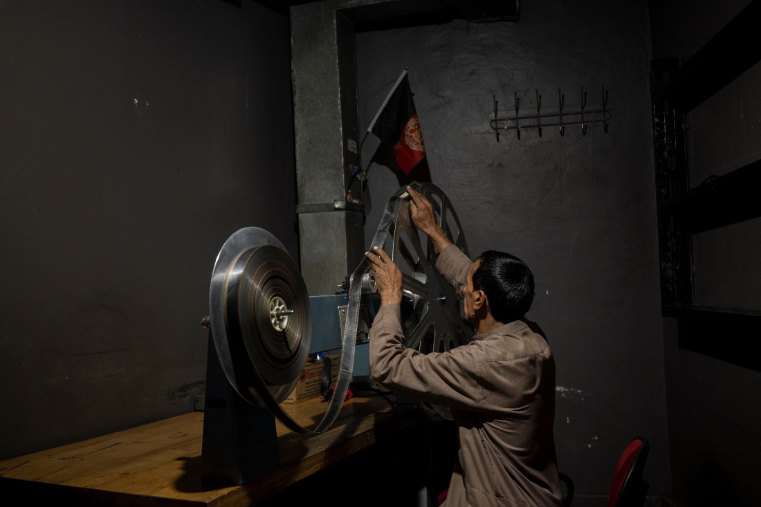 Rahmatullah Ezati plays back a film reel in the projection room of the historic Ariana Cinema in Kabul, Afghanistan. (AP)