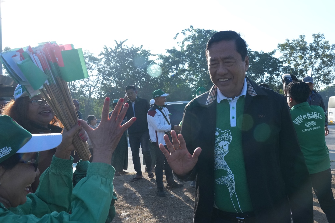 Maung Myint, right, a candidate of the military-backed Union Solidarity and Development Party, is welcomed by supporters during the final day of campaign for the first phase of a general election in Naypyitaw, Myanmar. (AP)