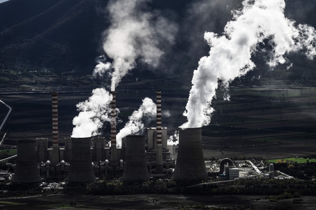 A photo of the Agios Dimitrios Power Station, a lignite-fired power plant next to solar panels in Agios Dimitros, near Kozani, in northwestern Greece. (AFP)