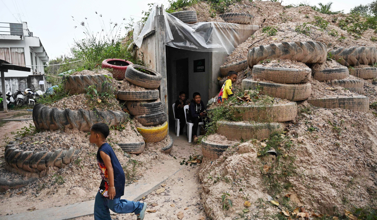 Children play around a bunker in Surin province on December 10, 2025, during clashes along the Thai-Cambodia border. (AFP)