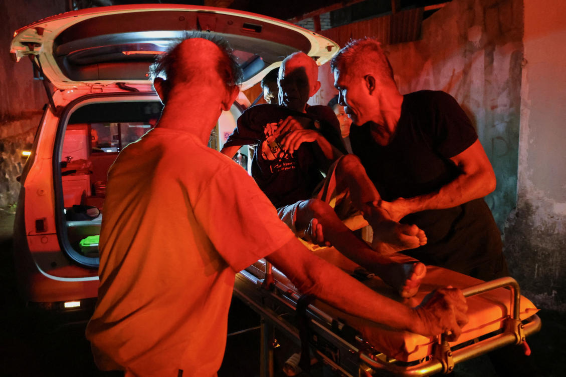 Local people rescue an elderly man during a fire at Werdha Damai retirement home in Manado, North Sulawesi Province, Indonesia, December 28, 2025. (Reuters)
