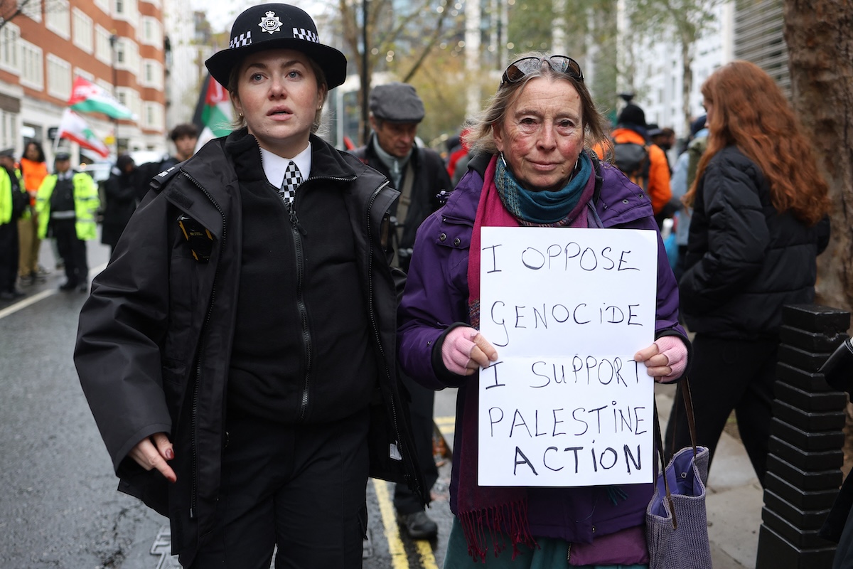 Police remove a protester for taking part in a demonstration in support Palestine Acton" during a demonstration in support of "Defend Our Juries" and their campaign against the ban on Palestine Action, outside Britain's Home Office in London on November 24, 2025. (FILE/AFP)