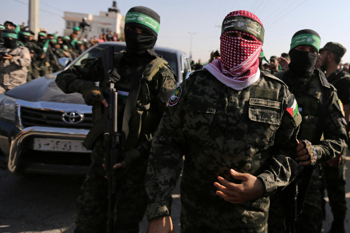 Abu Ubaida, the spokesman of the Izz el-Deen Al-Qassam Brigades, walks during an anti-Israel military show by Hamas militants in the southern Gaza Strip. (File/Reuters)