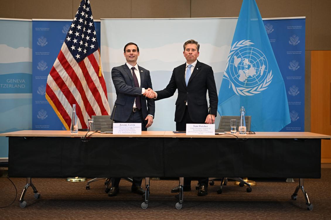 US Under Secretary of State for Foreign Assistance, Humanitarian Affairs and Religious Freedom Jeremy Lewin (L) shakes hands with United Nations Under-Secretary-General for Humanitarian Affairs Tom Fletcher during the signing ceremony of a $2 billion pledge of United States for United Nations humanitarian aid in 2026, at the US Mission in Geneva, on December 29, 2025. (AFP)