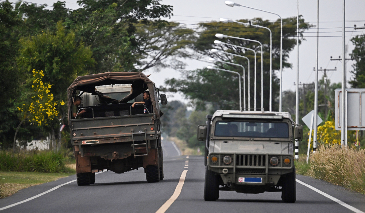 Thai military vehicles are pictured on a road in the Thai border province of Surin on December 11, 2025, amid clashes along the Thai-Cambodia border. (AFP)
