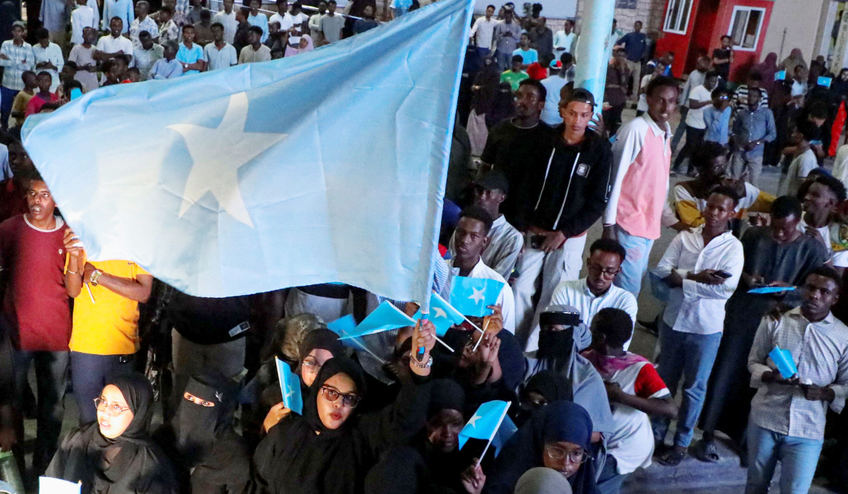 A woman holds a large Somali flag as Somalis attend a demonstration in Hodan district of Mogadishu, Somalia, December 28, 2025. (REUTERS)