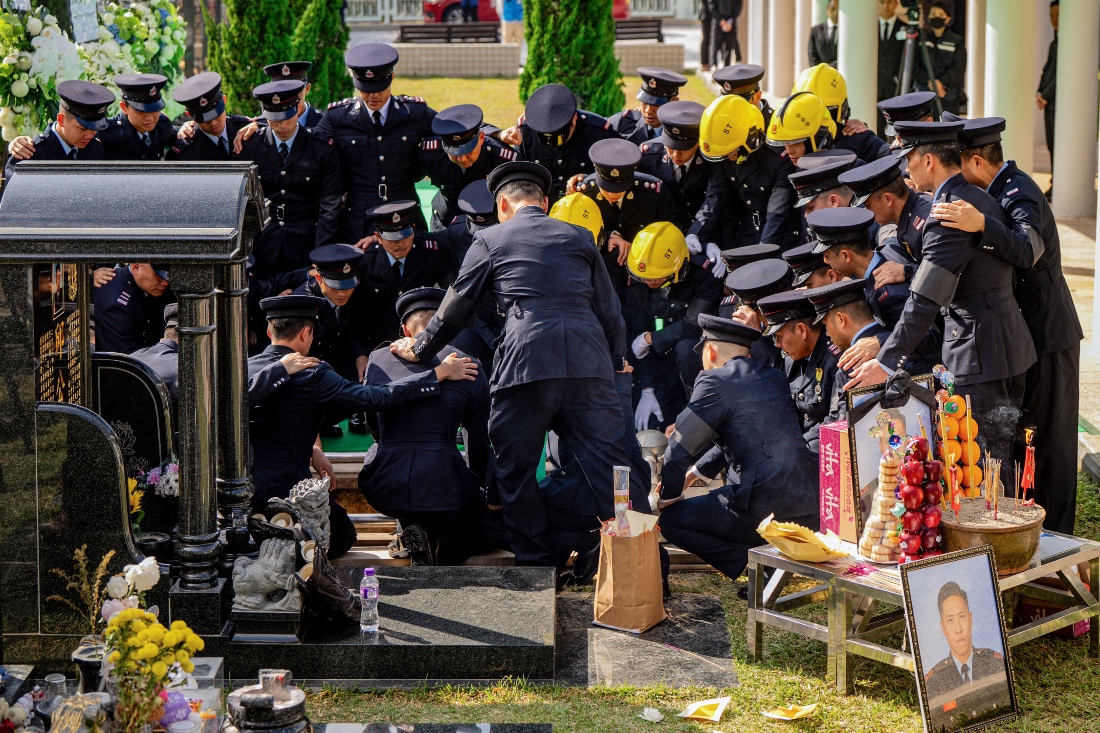 Fire Services Department members mourn at the funeral for firefighter Ho Wai-ho,who died in the deadly fire at the Wang Fuk Court residential estate in Tai Po district, Hong Kong. (AFP)