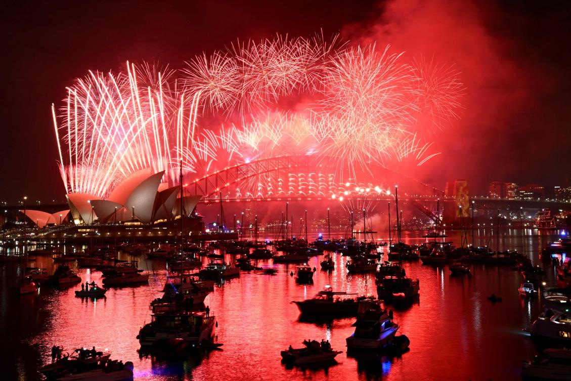 Fireworks light up the midnight sky over Sydney Harbour Bridge and Sydney Opera House during New Year’s Day celebrations. (AFP)