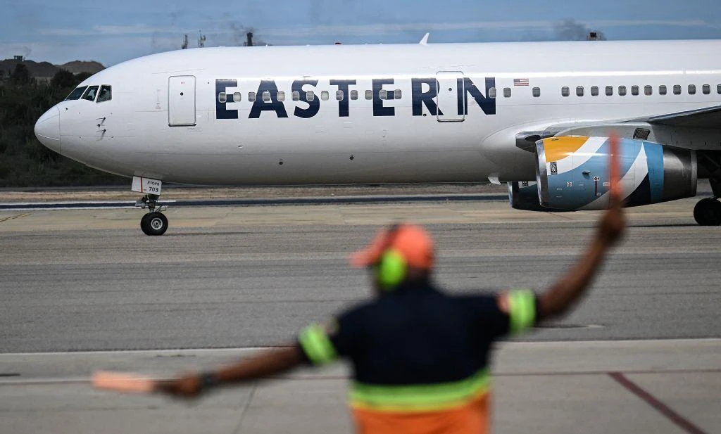 An Eastern Airlines plane carrying Venezuelan migrants repatriated from the US lands at Simon Bolivar International Airport in Maiquetia, Venezuela, Nov. 26, 2025. (Juan Barreto / AFP)