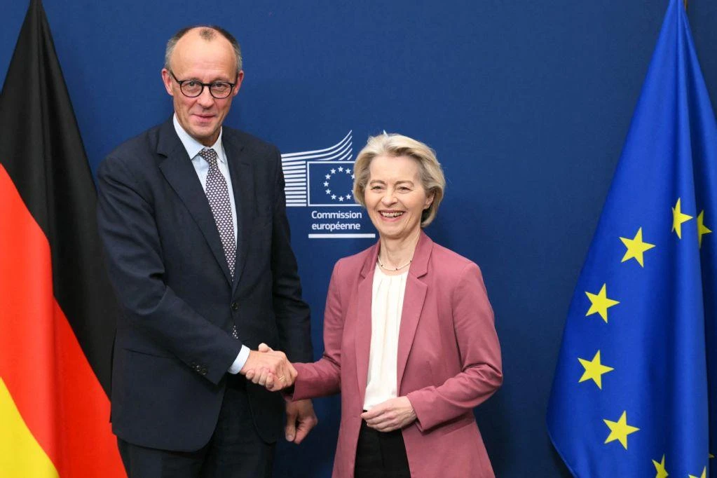 European Commission President Ursula von der Leyen greets Germany's Chancellor Friedrich Merz (L) to discuss the use of frozen Russian assets to finance Ukraine, at the EU Commission in Brussels on December 5, 2025. (AFP)