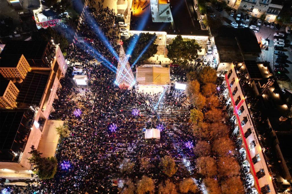 An aerial photograph shows people gathering in Nativity Square during a Christmas tree lighting ceremony in Bethlehem, in the Israeli-occupied West Bank, on Dec. 6, 2025. (AFP)