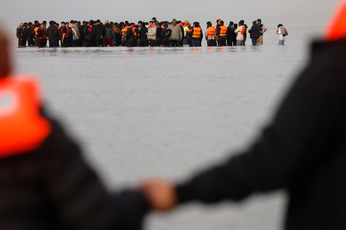 Migrants push a small boat in an attempt to reach Britain, Thursday, Nov. 6, 2025 in Gravelines, northern France. (AP)