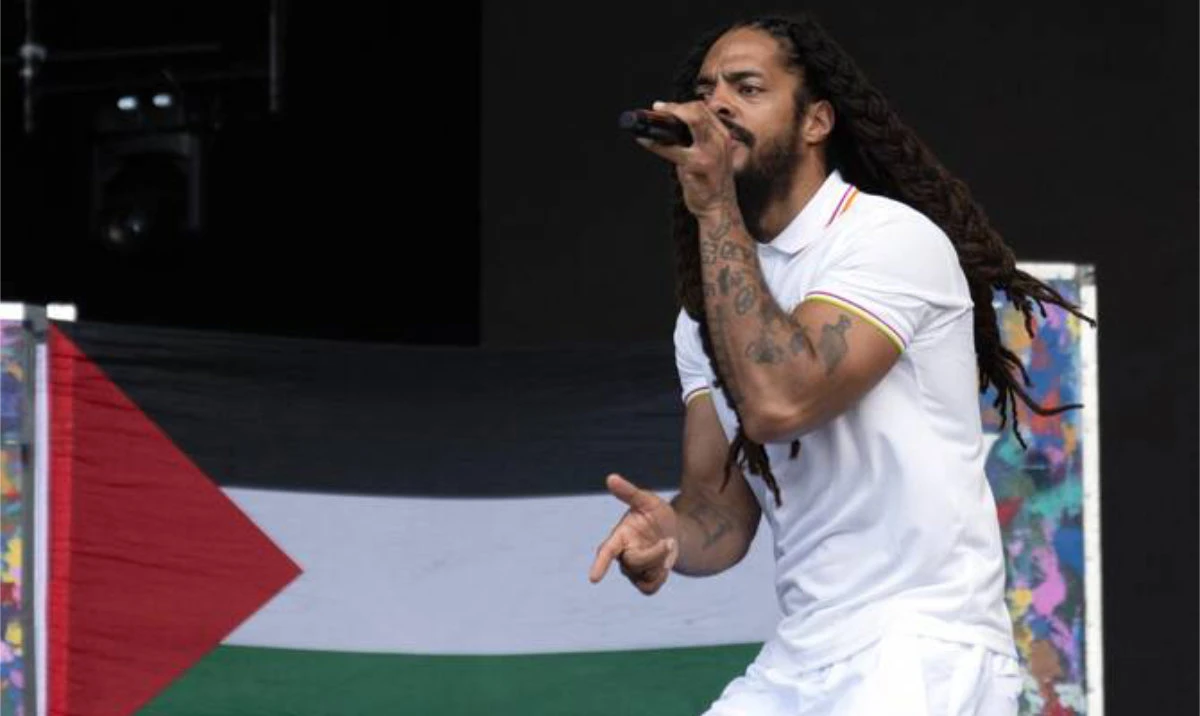 Bob Vylan performing in front of a Palestinian flag at Glastonbury in June. The group are suing RTE for a report accusing them of being antisemitic during the performance. (AFP/File)